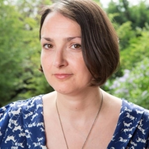 Writer Hannah Khalil headshot, with a green outdoor background