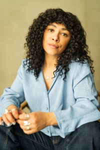 Writer Jade Jordan, headshot with beige background.