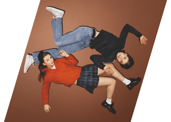 For Dolores image. Both actors lying flat on a burnt orange background, limbs laid out in different directions.
