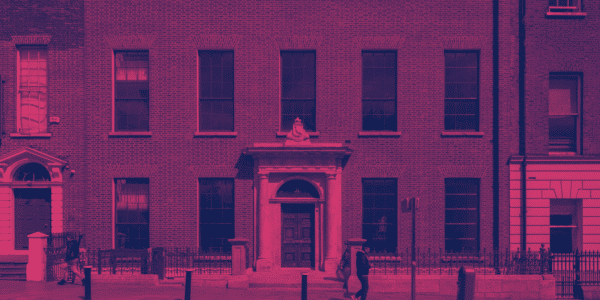 Image of 11 Parnell Square, the home of Poetry Ireland. A red bricked Georgian building. The image has a pink hue layered over it.